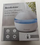 Brookstone Cool Mist Ultrasonic Aroma Diffuser W/ Essential Oil & Soft Blue Led. Fixed Price $12.55.